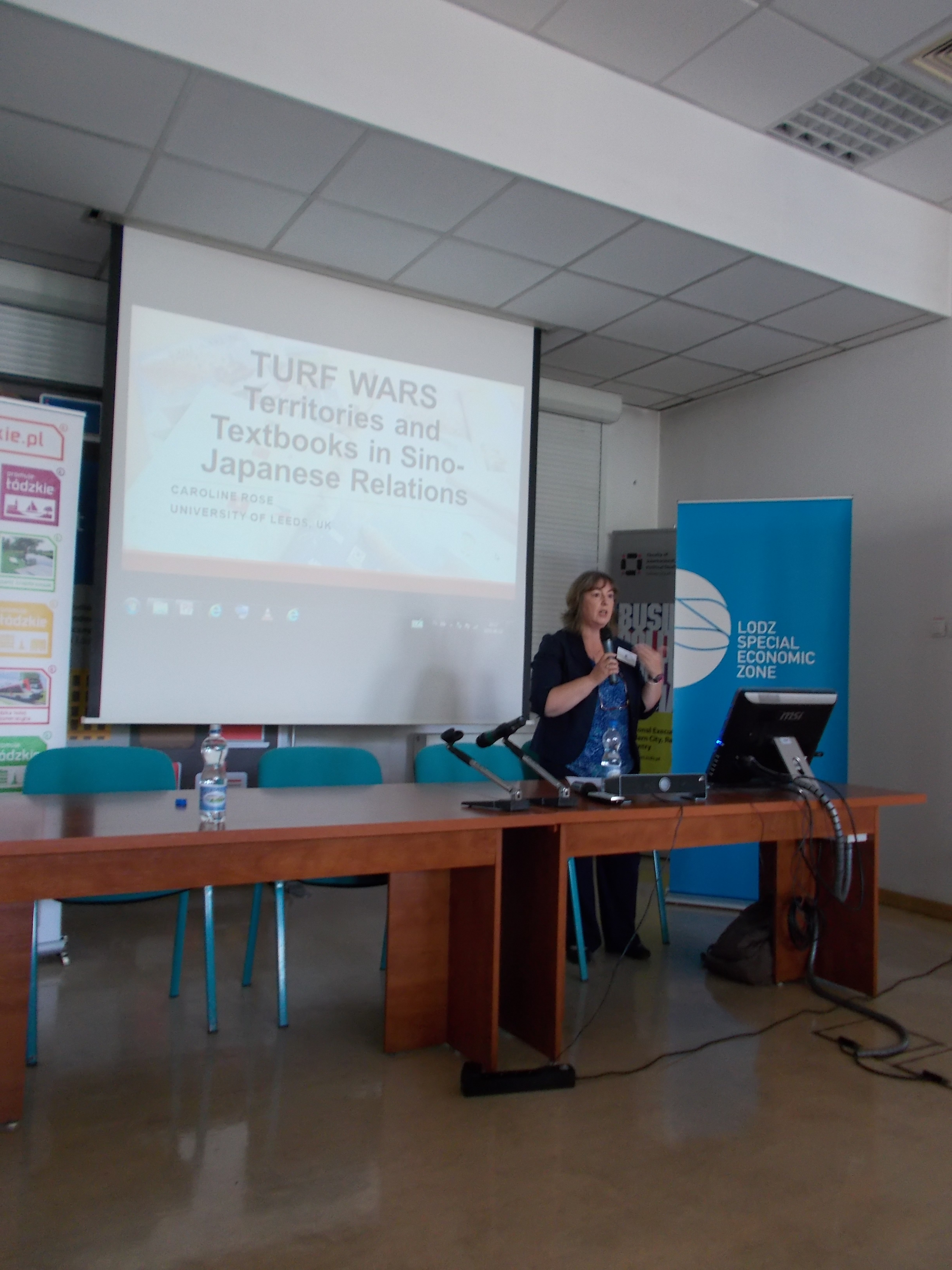 Close-up of panelist during a debate – speaker at a conference table in the middle of a presentation.