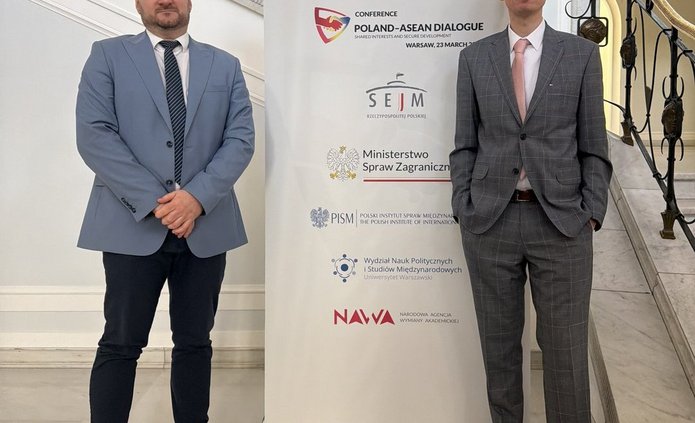 Dr. Zaręba and Dr. Chatys by the banner of the Poland–ASEAN Dialogue event