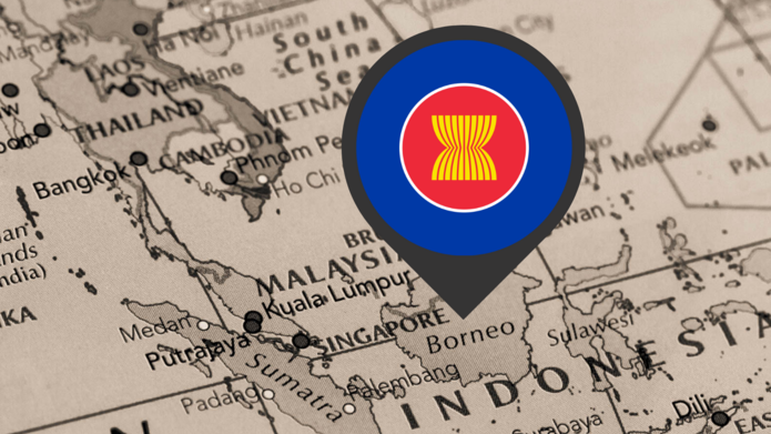 Pinezka z logo ASEAN wbita w mapę Indonezji/A pin with the ASEAN logo stuck into the map of Indonesia